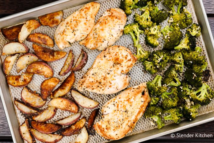 Roasted chicken with potatoes and broccoli on a sheet pan.