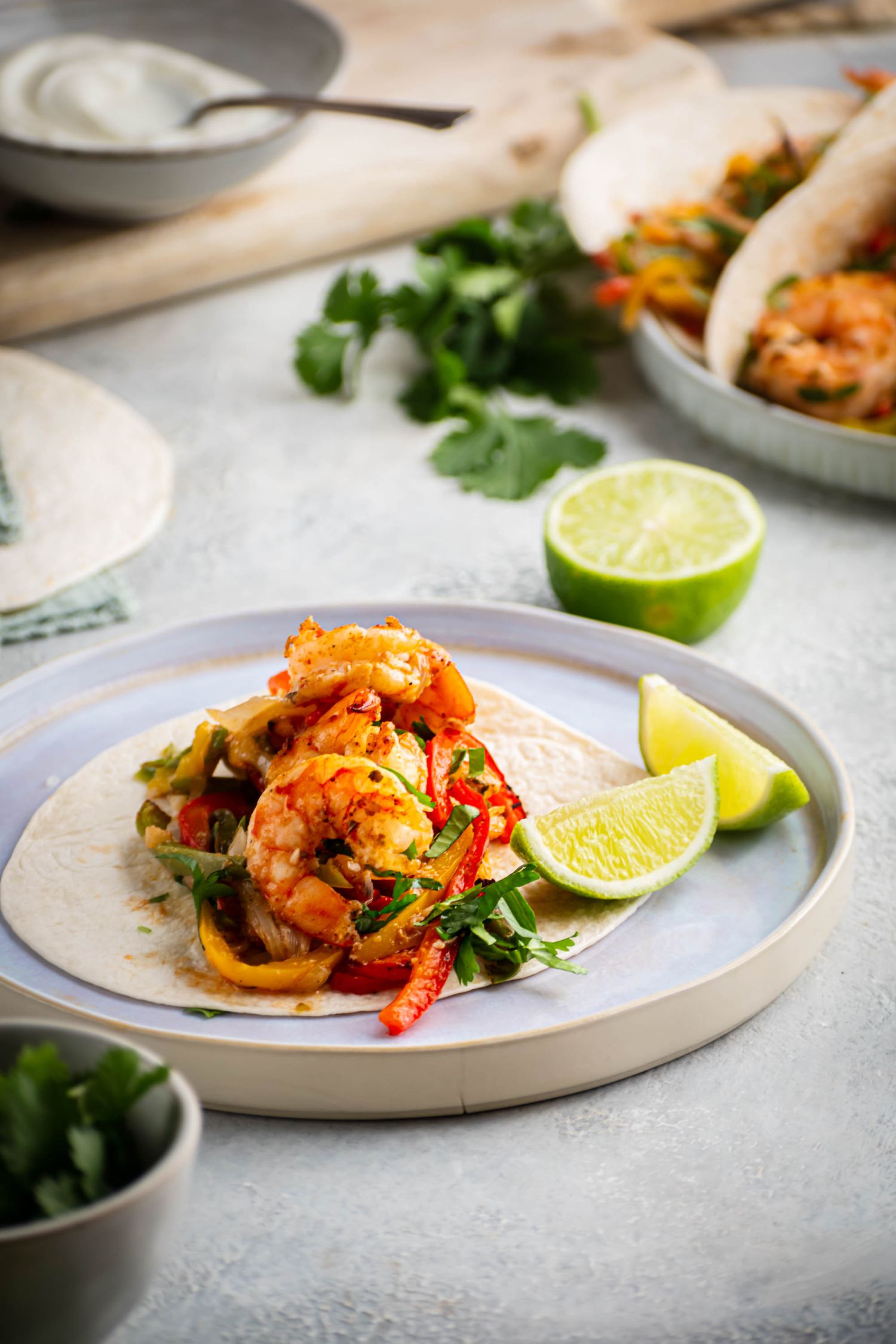 Restaurant style shrimp fajitas served on warm tortillas with cilantro, peppers, and onions.