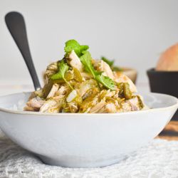 Slow cooker chicken chile verde with tomatillo salsa in a bowl with rice and cilantro.