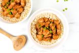 Slow cooker honey garlic chicken with green onions over a bed of brown rice.