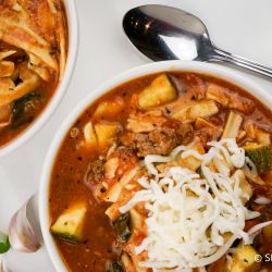 Slow Cooker lasagna soup in a crockpot with noodles, beef, and zucchini.