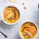 Slow cooker steel cut oatmeal with pumpkin pie spices on a plate with sliced banana.