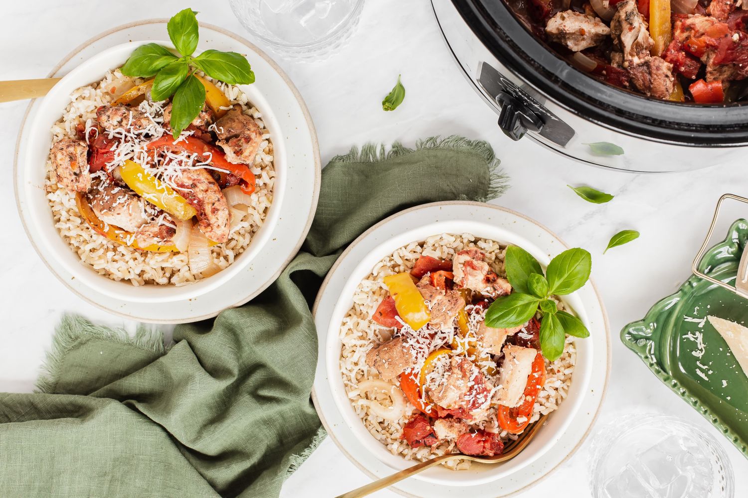 Slow cooker red pepper Italian chicken in a bowl with cooked chicken breast, bell peppers, garlic over white rice.