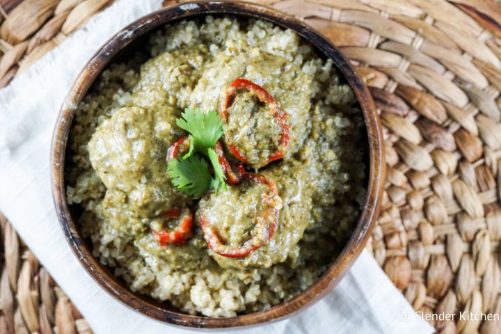 Slow cooker Thai curry meatballs with ground chicken, fresh herbs, and coconut milk in a bowl with rice. 