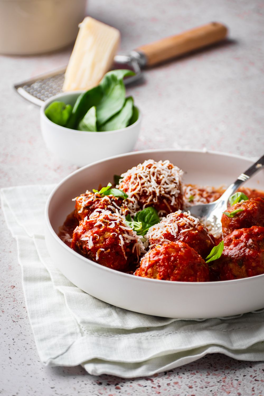 Turkey meatballs made in the slow cooker with marinara sauce and served with fresh basil and Parmesan cheese.