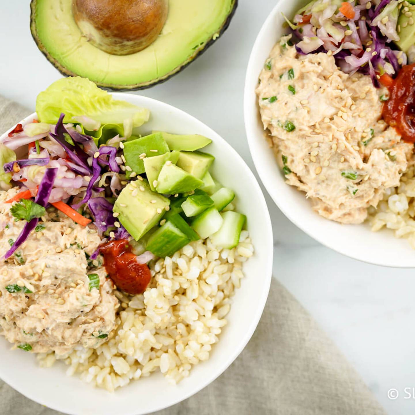 Spicy tuna bowls with spicy tuna salad, avocado, cucumbers, and brown rice.