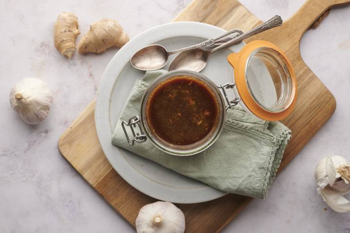 Stir fry sauce made with soy sauce, honey, rice vinegar, garlic, ginger, and cornstarch in a jar.