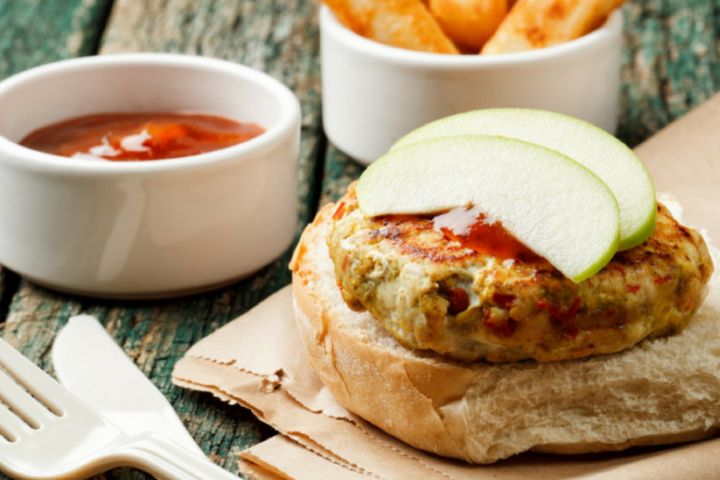 Turkey Apple Burgers on a bun with a slice of apple on top.