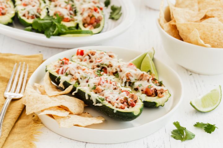 Turkey Fajita Zucchini Boats with ground turkey, pepper, onions, and tomatoes in hollowed out zucchini with melted cheese.