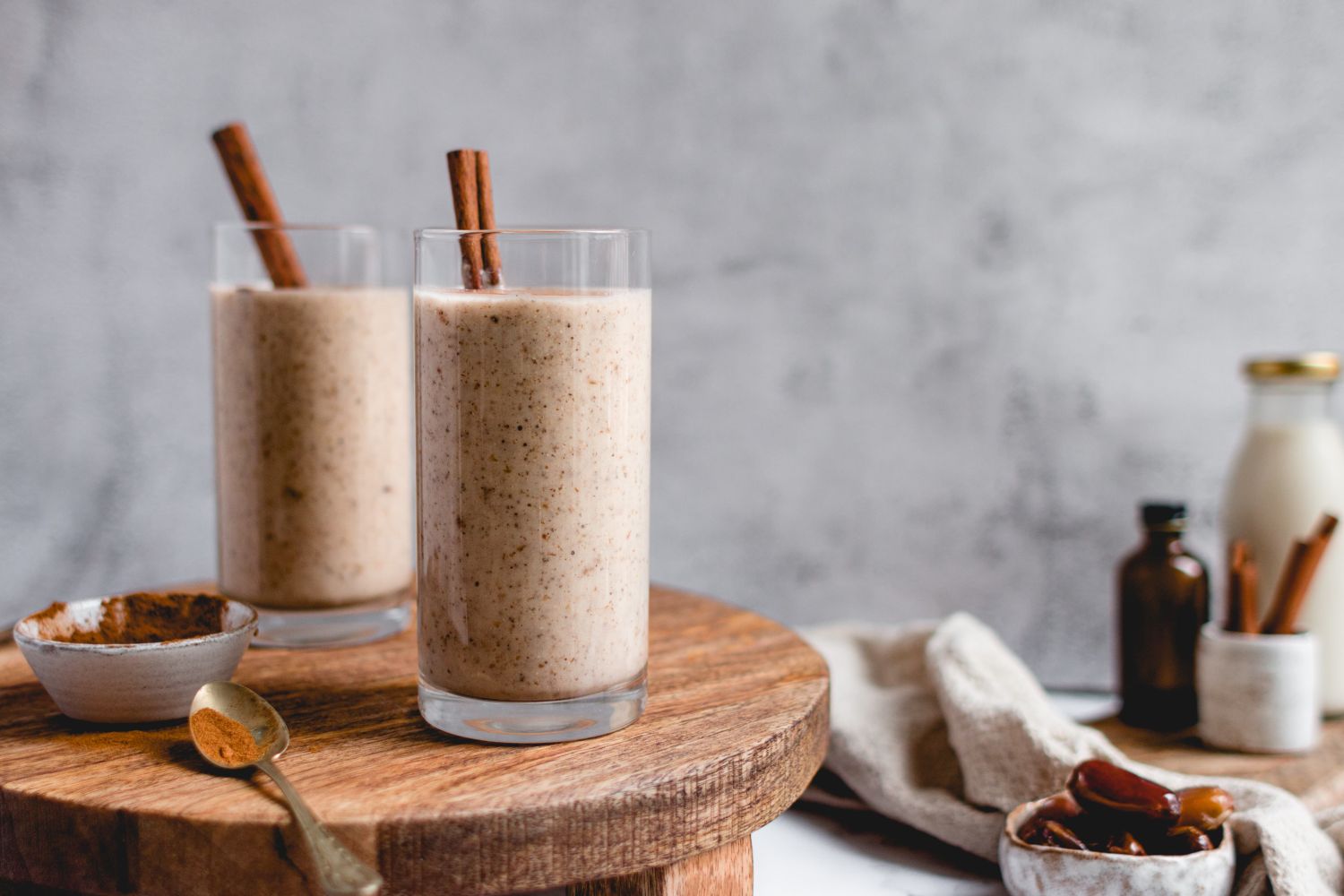 Vanilla cinnamon protein shake with bananas, cauliflower, protein, cinnamon, and almond butter poured in two glasses.