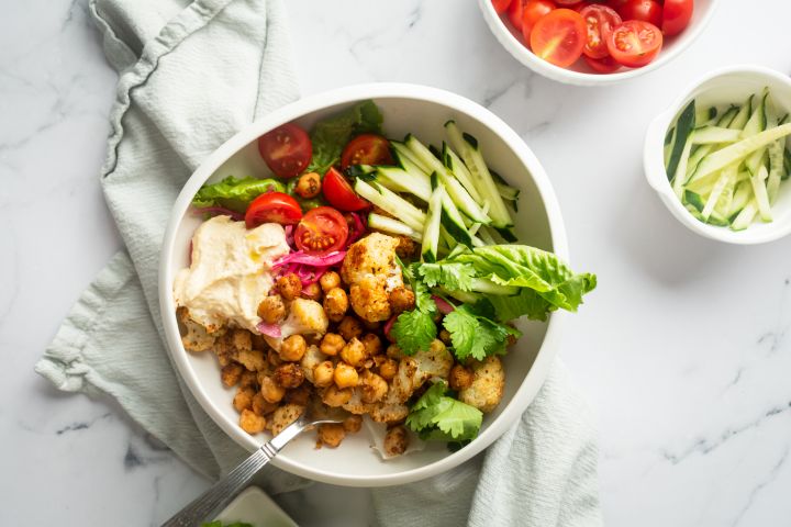 Vegetarain shawarma bowl with roasted chickpeas, cauliflower, and fresh vegetables.